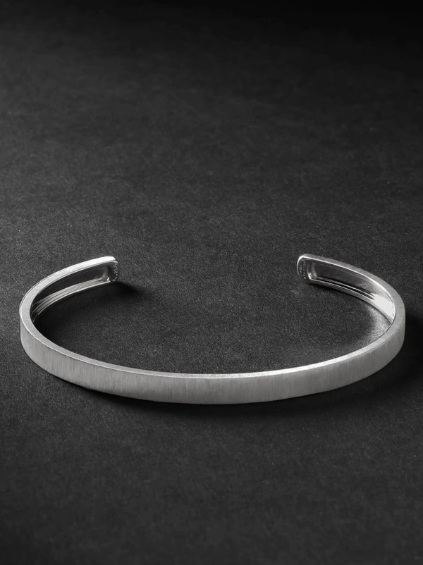 <a href="https://www.mrporter.com/en-us/mens/product/buccellati/fine-jewellery/bracelets/macri-white-gold-cuff/18706561955675919">BUCCELLATI Macri White Gold Cuff from Mr Porter, $5,200</a>
