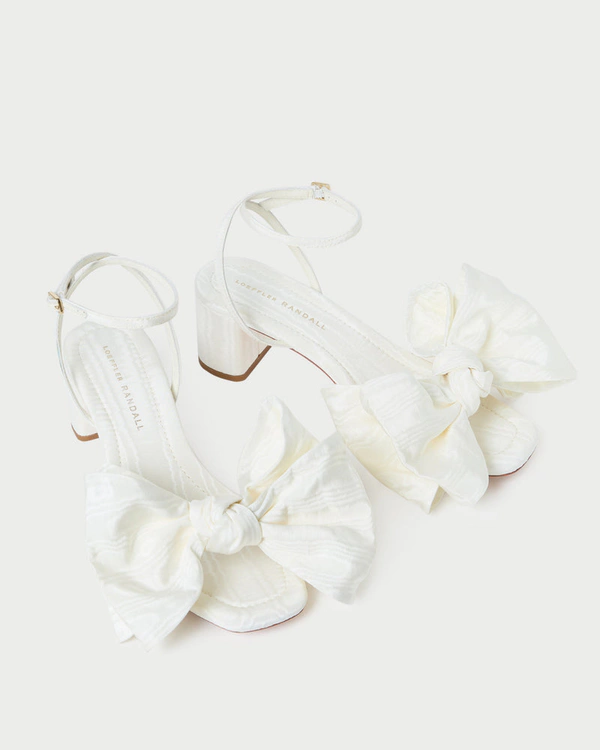 <a href="https://loefflerrandall.com/collections/brides/products/carmen-cream-moire-bow-sandal">LOEFFLER RANDALL Carmen Cream Moiré Bow Sandal</a>, $350