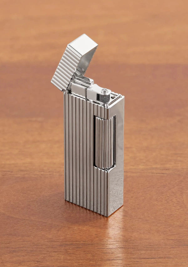 <a href="https://www.mrporter.com/en-us/mens/product/dunhill/lifestyle/home-accessories/rollagas-palladium-plated-lighter/46376663162991448">DUNHILL Rollagas Palladium-Plated Lighter from Mr Porter, $1,500</a>
