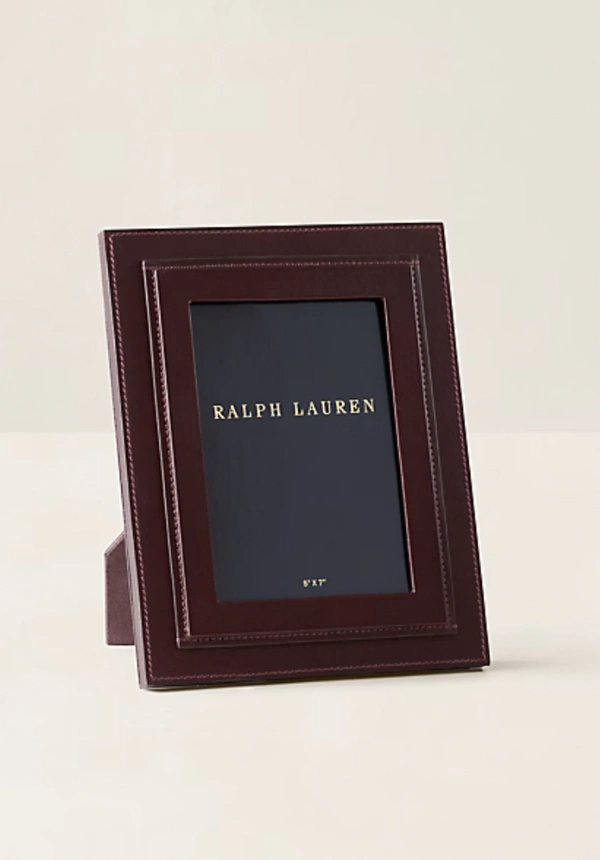 <a href="https://www.ralphlauren.com/home-decor-artwork-frames/brennan-leather-frame/400099.html?dwvar400099_colorname=Burgundy&cgid=home-decor-artwork-frames#ab=en_US_HomeLP_Slot_3_S1_Image1_SHOP&start=1&cgid=home-decor-artwork-frames">RALPH LAUREN HOME Customizable Brennan Leather Frame, $350</a>