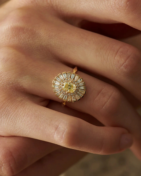 <a href="https://www.artemerstudio.com/collections/color/products/daisy-engagement-ring-fancy-yellow-diamond-and-baguette-diamond-ring">Artemer Studio</a>