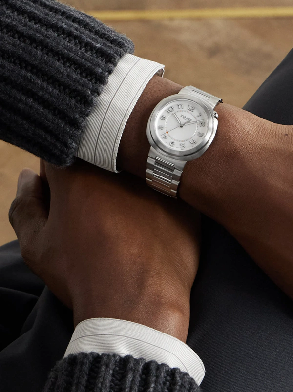 <a href="https://www.mrporter.com/en-us/mens/product/hermes-timepieces/luxury-watches/dress-watches/cut-automatic-stainless-steel-watch-ref-403190ww00/1647597347980875">HERMES Cut Automatic Stainless Steel Watch from Mr. Porter, $7,775</a>