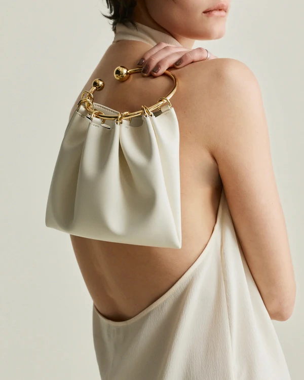 <a href="https://verafiedny.com/collections/the-ring-bag/products/cream-ring-handle-bag">VERAFIED Bag</a>, $198