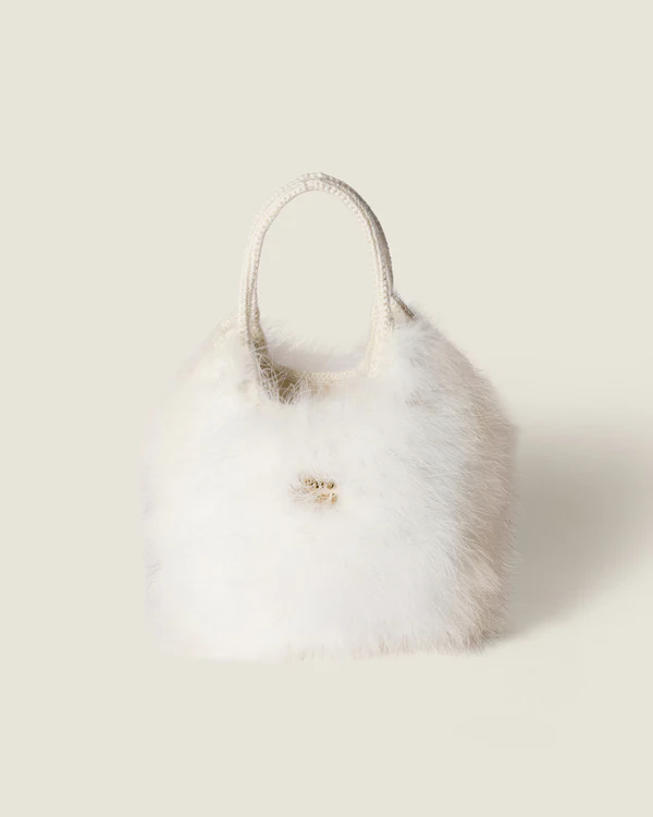 <a href="https://www.miumiu.com/us/en/p/ivy-crochet-handbag-with-feathers/5BA281_2CVC_F0009_V_CWN">MIU MIU Bag</a>, $5,100
