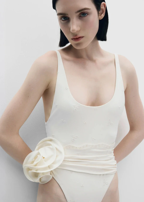 <a href="https://www.magdabutrym.com/us-en/product/pf26-swimsuit-05-cream-embroidery">MAGDA BUTRYM Swimsuit</a>, $635