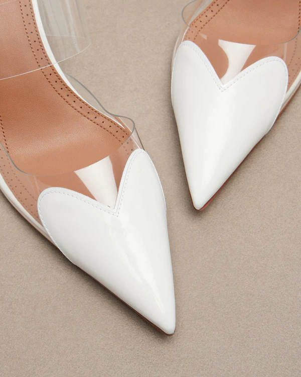 <a href="https://www.mytheresa.com/us/en/women/alaia-le-coeur-patent-leather-wedge-mules-white-p01183644">ALAÏA Le Coeur Patent Leather Wedge Mules</a> from Mytheresa, $1,450