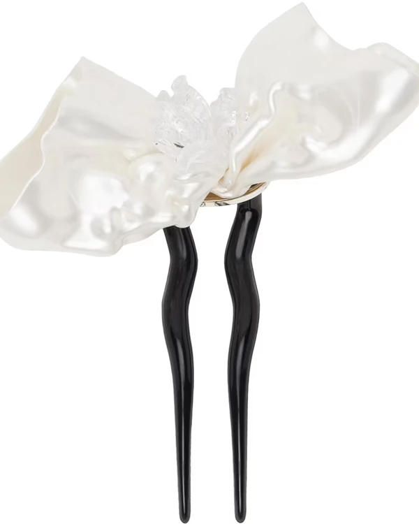 <a href="https://www.ssense.com/en-us/women/product/florence-tetier/ssense-exclusive-off-white-floral-hair-pin/15305681">TETIER BIJOUX Off-White Floral Hair Pin</a> from Ssense, $660