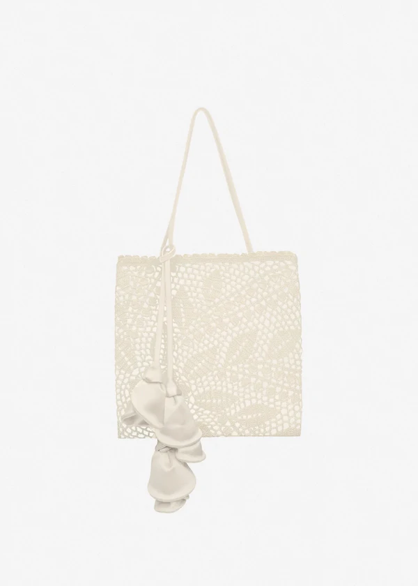 <a href="https://www.magdabutrym.com/us-en/product/aw26-julia-bag-cream-satin-with-cream-crochet">MAGDA BUTRYM Bag</a>, $1,350
