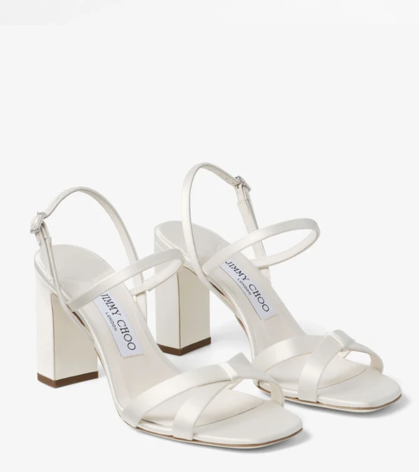<a href="https://us.jimmychoo.com/en/women/shoes/elsy-block-heel-85/ivory-satin-sandals-with-crystal-embellished-buckle-ELSYBH85TCU080002.html?geoip=geoip&amp;updatePreLocale=true&amp;cm_mmc=GoogleUS-_-Shopping-_-Shopping-_-J00018106838&amp;gclsrc=aw.ds&amp;gad_source=1&amp;gad_campaignid=23228074314&amp;gbraid=0AAAAADvZht0w3u0BW1SpWqInw2Lk3bxjl&amp;gclid=CjwKCAjw_KjVBhAHEiwAnC0N9MN_gJ1rD96EBukcJbSDepc873Kpf7P6UIrINnxDnhHaqAqlAlr8KRoCA3oQAvD_BwE">JIMMY CHOO Ivory Satin Block Heel Sandals, $895</a>
