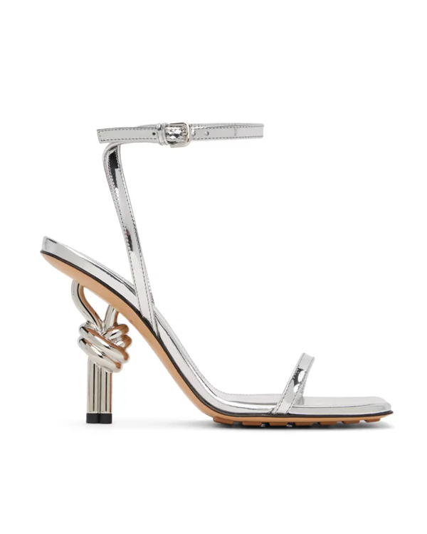 <a href="https://www.ssense.com/en-us/women/product/bottega-veneta/silver-knot-sandals/14734891">BOTTEGA VENETA Sandals from Ssense</a>, $1,800