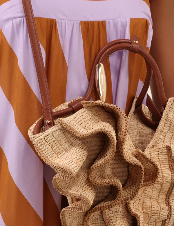 <a href="https://www.zimmermann.com/us/accessories/goldentime-small-ruffle-tote-natural.html">ZIMMERMANN Ruffle Tote</a>, $675