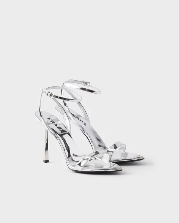 <a href="https://www.prada.com/us/en/p/metallic-leather-high-heeled-sandals/1X923M_3AU1_F0118_F_DD100?utm_campaign=GoogleShopping_US&amp;utm_medium=CPC&amp;utm_source=Google&amp;utm_content=PMax&amp;s_kwcid=AL!8549!3!!!!x!!&amp;gclsrc=aw.ds&amp;gad_source=1&amp;gad_campaignid=15775671799&amp;gbraid=0AAAAADgVuh_8CdFUTf9E53fs_ecavdlSr&amp;gclid=Cj0KCQjwuJLWBhD_ARIsAIBcRUy4CU3Tw_DNkF4GsvlcxcFF43UOTyFZeJQa4QljjVKQq_qOVjUDqUEaAv9GEALw_wcB">PRADA Sandals</a>, $1,320