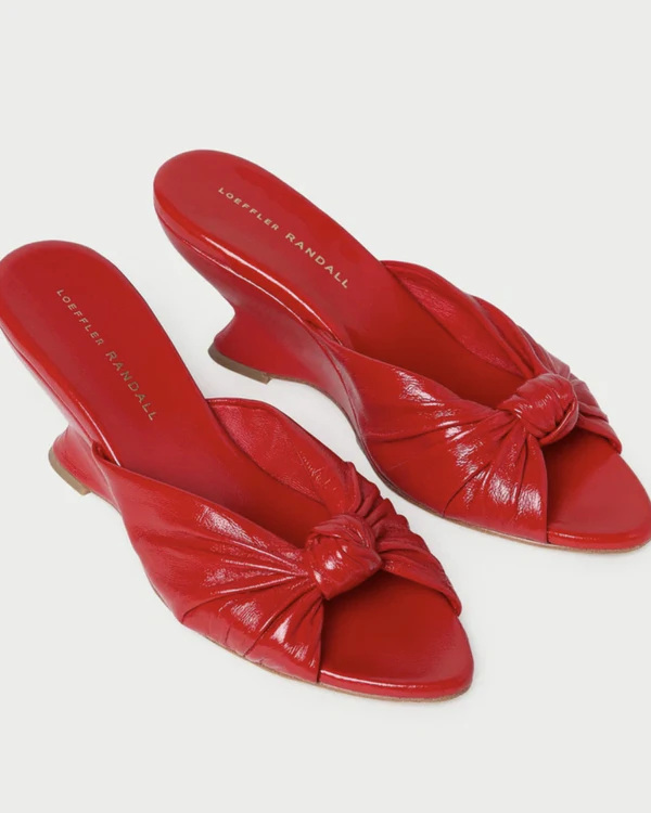 <a href="https://loefflerrandall.com/collections/heeled-sandals/products/marsy-red-leather-knot-wedge">LOEFFLER RANDALL Red Wedge Sandals, $375</a>