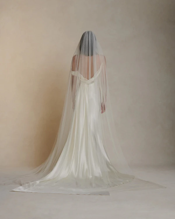 <a href="https://www.daniellefrankelstudio.com/products/simple-tulle-veil">DANIELLE FRANKEL Veil</a>, $990