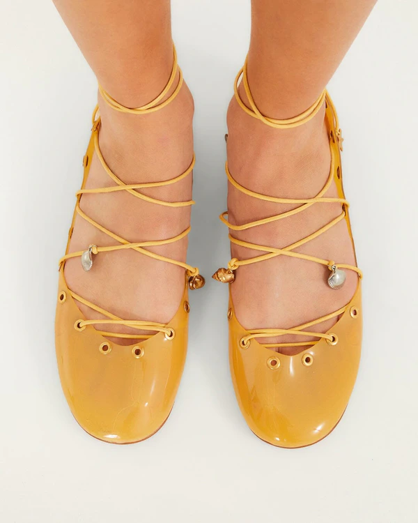 <a href="https://farmrio.com/products/sea-lace-up-jelly-ballerina">FARM RIO Yellow Sea Lace Up Jelly Ballerina</a>, $238