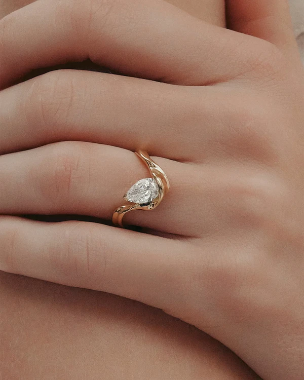 <a href="https://www.sarahandsebastian.com/en-us/products/marine-pear-engagement-ring-yellow-gold">SARAH &amp; SEBASTIAN Ring</a>, $16,000