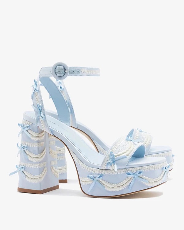 <a href="https://larroude.com/products/blue-dolly-cake-lace-sandal-satin?_pos=1&_sid=d573a51b0&_ss=r">LARROUDÉ x TANNER FLETCHER Dolly Cake & Lace Sandal</a>, $450