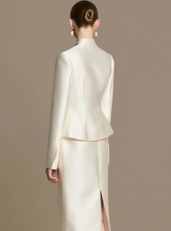 <a href="https://www.huongboutique.com/products/silhouette-jacket-cream-white?pr_prod_strat=jac&amp;pr_rec_id=c2754b894&amp;pr_rec_pid=10172386148659&amp;pr_ref_pid=10172380479795&amp;pr_seq=uniform" target="_blank" rel="noopener noreferrer">HUONG Jacket</a><span>, $240;&nbsp;</span><a href="https://www.huongboutique.com/products/blanc-taffeta-midi-skirt?pr_prod_strat=jac&amp;pr_rec_id=e8a782486&amp;pr_rec_pid=10172380479795&amp;pr_ref_pid=10172386148659&amp;pr_seq=uniform" target="_blank" rel="noopener noreferrer">HUONG Skirt</a><span>&nbsp;$100</span>