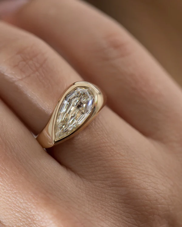 <span><a href="https://www.artemerstudio.com/collections/engagement/products/step-cut-pear-shape-diamond-solitaire-ring">ARTEMER Ring</a>, $16,000</span>