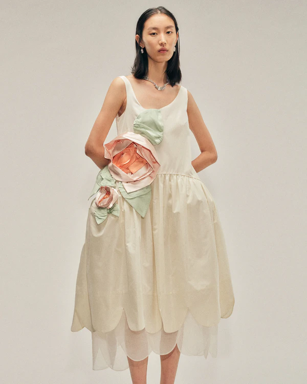<a href="https://shop-us.simonerocha.com/collections/womenswear/products/7448-0469-cream-multi" target="_blank">SIMONE ROCHA Pressed Rosette Tilted Neck Petal Hem Dress, $1,905</a>
