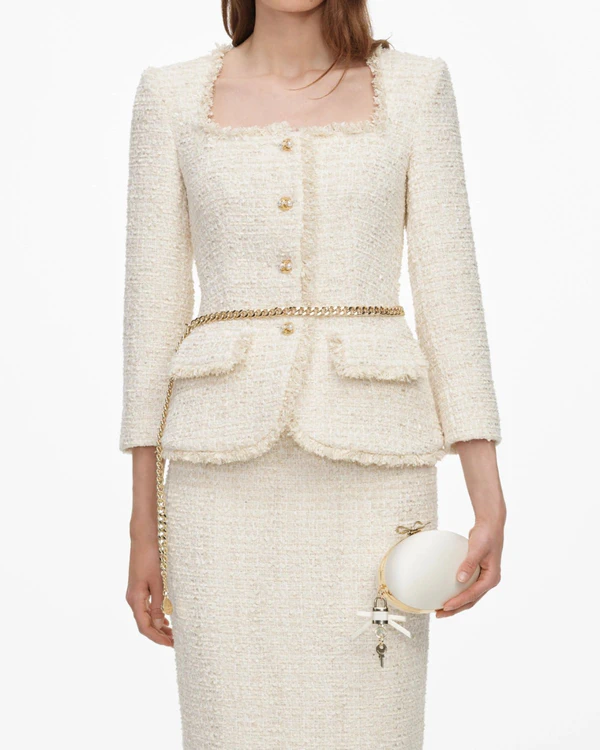 <a href="https://us.self-portrait.com/products/aw26-cream-boucle-tailored-chain-midi-dress?country=us">SELF-PORTRAIT Dress</a>, $780