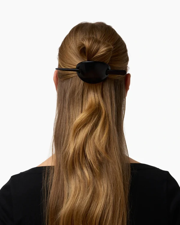 <a href="https://lie-studio.com/products/the-frida-hair-pin-silver?shpxid=5f72fe1e-7009-4532-a7a5-ed0342b1f104">LIÉ STUDIO </a><span style="font-family: 'GT America', sans-serif;"><a href="https://lie-studio.com/products/the-poppy-barrette-black?shpxid=7067056f-d9de-4ec3-bd02-209f7093fe34">The Poppy Barrette</a>, $90</span>