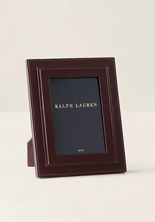 <a href="https://www.ralphlauren.com/home-decor-artwork-frames/brennan-leather-frame/400099.html?dwvar400099_colorname=Burgundy&cgid=home-decor-artwork-frames#ab=en_US_HomeLP_Slot_3_S1_Image1_SHOP&start=1&cgid=home-decor-artwork-frames">RALPH LAUREN HOME Customizable Brennan Leather Frame, $350</a>