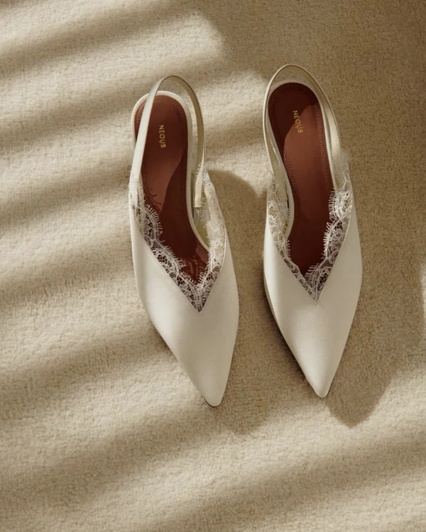 <a href="https://www.neous.co.uk/products/irena-crepe-de-chine-slingback-cream">NEOUS Irena Pumps</a>, $790