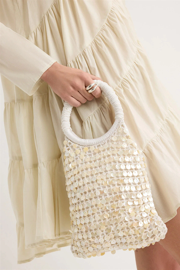 <a href="https://merlettenyc.com/products/maris-shell-bag-in-ivory">MERLETTE Bag</a>, $420