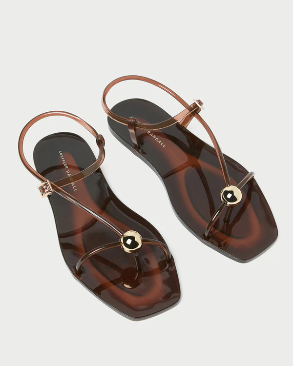 <a href="https://loefflerrandall.com/products/dana-brown-strappy-jelly-sandal?_pos=3&_sid=bf1a969d6&_ss=r#search">LOEFFLER RANDALL Dana Brown Strappy Jelly Sandal</a>, $175