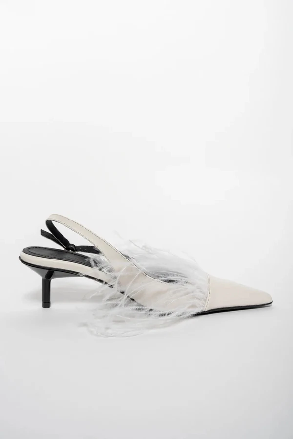 <a href="https://www.marquesalmeida.com/collections/shoes/products/white-feather-pumps-1">MARQUES ALMEIDA White Feather Sling Backs Pumps</a>, $258