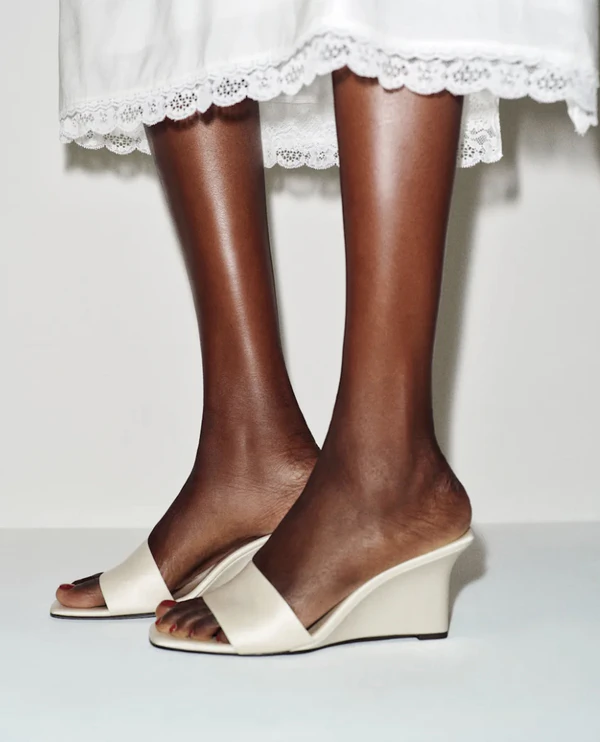 <a href="https://www.thereformation.com/products/gabriella-wedge/1320518YPP.html?_gl=1*1a3igun*_up*MQ..&amp;gclid=CjwKCAjw_KjVBhAHEiwAnC0N9DF-3jIUfsENWQqtITtit8wdQU76NJSIHPVF-FDdbDH299cdCElpehoC84MQAvD_BwE&amp;gbraid=0AAAAADmLagUekqBwbJq6pWsecmzoPJeGK&amp;dwvar_1320518YPP_color=DLT&amp;quantity=1">REFORMATION Satin Wedge, $328</a><b></b>