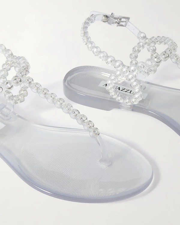 <a href="https://www.net-a-porter.com/en-us/shop/product/aquazzura/shoes/flat/almost-bare-crystal-embellished-pvc-sandals/46376663162862882">AQUAZZURA Almost Bare Crystal-Embellished PVC Sandals</a> from Net-a-Porter, $450