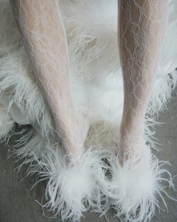 <a href="https://us.ilkyazozel.com/products/mule-90-white-silk-satin-with-feathers">ILKYAZ OZEL Heels</a>, $850