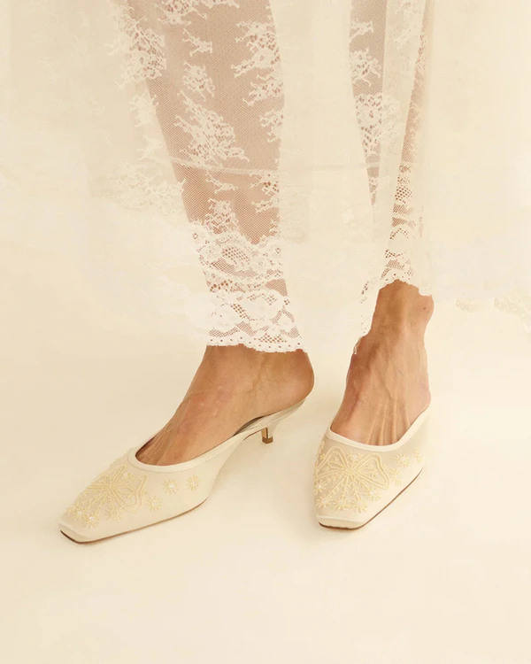 <a href="https://www.shopdoen.com/products/malin-mule-embellished-eggshell-satin">DÔEN Malin Mule</a>, $448