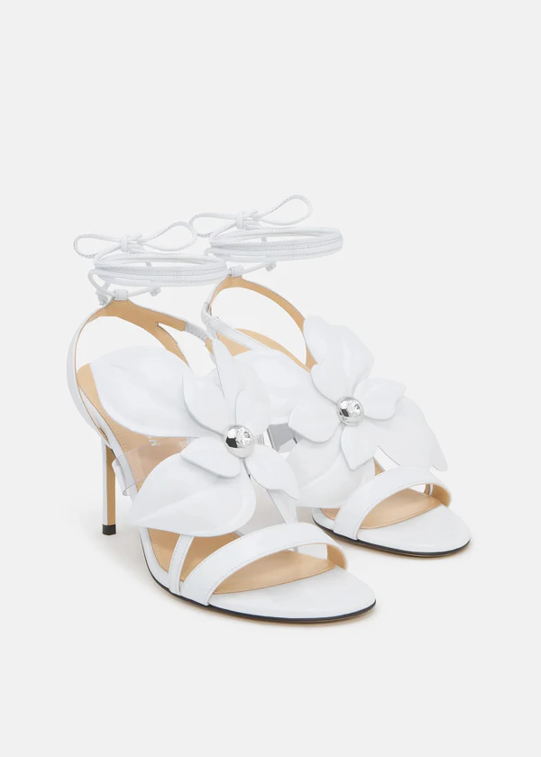 <a href="https://machandmach.com/products/orchid-round-toe-sandals-white?_gl=1*1dnk5wm*_up*MQ..*_ga*OTE1MDcxMTA2LjE3ODE4OTQ2NjA.*_ga_N8QBVBWCCC*czE3ODE4OTQ2NTkkbzEkZzEkdDE3ODE4OTQ2OTUkajI0JGwwJGgw*_ga_7NVNMZST7Z*czE3ODE4OTQ2NTkkbzEkZzEkdDE3ODE4OTQ3MDEkajE4JGwwJGg2MzE3NjIzNjY.&variant=46511876767992">MACH & MACH Orchid Round Toe Sandals</a>, $1,195