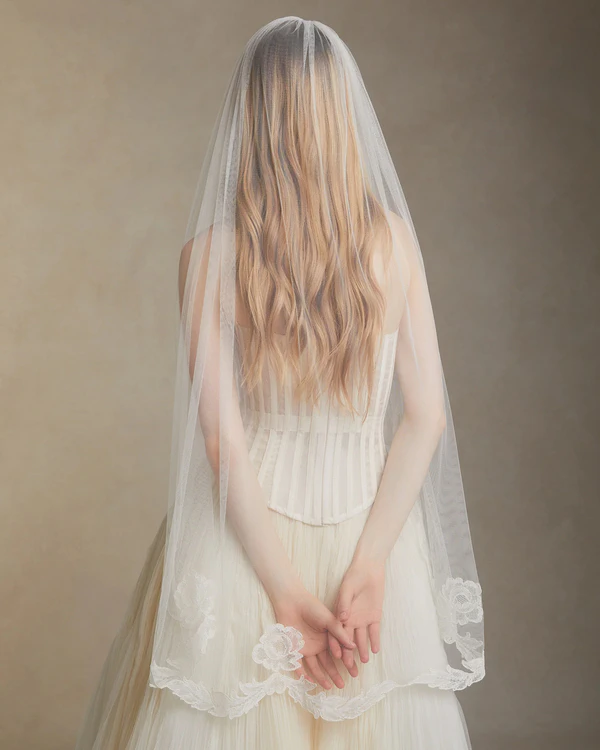 <a href="https://www.daniellefrankelstudio.com/products/camellia-fingertip-veil">Danielle Frankel</a>