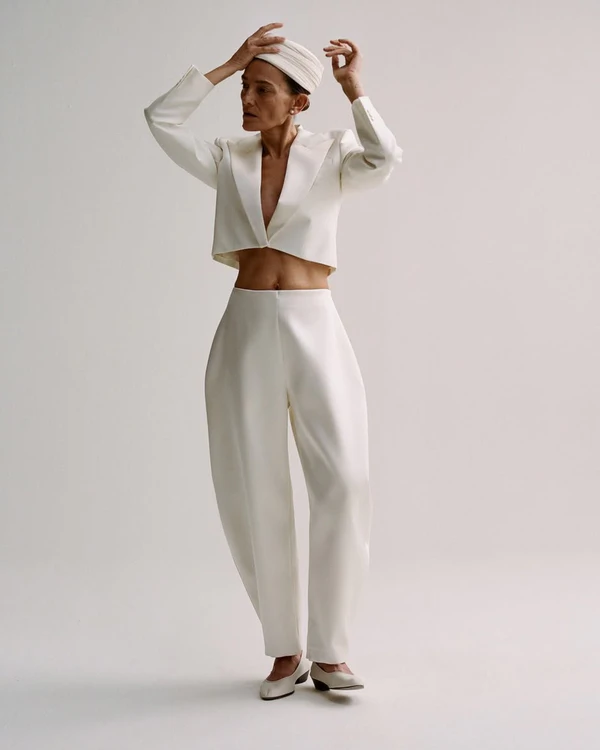 <a href="https://us.roheframes.com/collections/la-mariee/products/double-breasted-waisted-blazer-off-white">ROHE Jacket</a>, $1250, <a href="https://us.roheframes.com/products/sculptural-satin-trousers-ivory">ROHE Pants</a>, $940