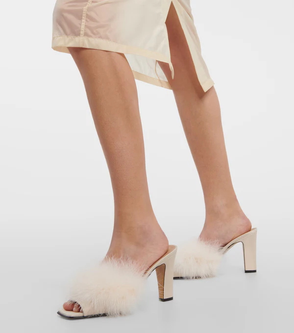 <a href="https://www.mytheresa.com/us/en/women/maison-margiela-feather-embellished-mules-white-p00877249">MAISON MARGIELA Mules from Mytheresa</a>, $534