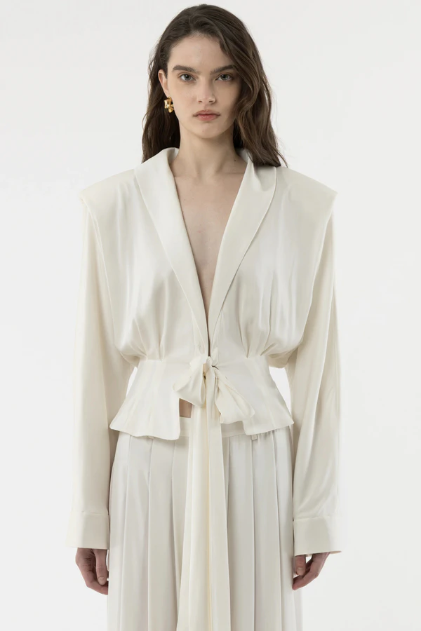 <a href="https://arakii.com/p/front-tie-silk-blouse-off-white">ARAKII Blouse</a>, $590, <a href="https://arakii.com/p/pleated-silk-pants-off-white">ARAKII Pants</a>, $560