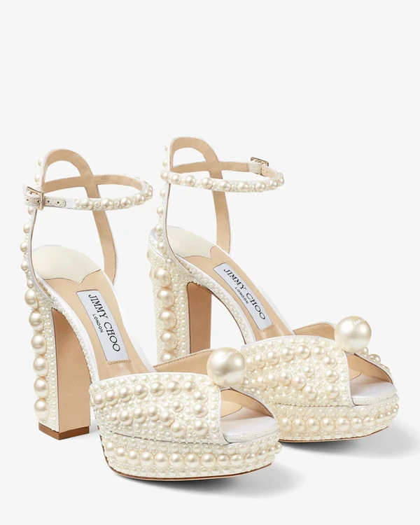 <a href="https://us.jimmychoo.com/en/women/shoes/sacaria-platform-120/white-satin-platform-sandals-with-all-over-pearl-embellishment-SACARIAPF120WOZ080308.html">JIMMY CHOO Sacaria Platform 120</a>, $2,095