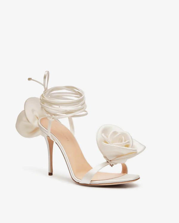 <a href="https://www.mytheresa.com/us/en/women/magda-butrym-leather-trimmed-satin-sandals-white-p00746462">MAGDA BUTRYM Floral Appliqué Satin Sandals</a> from Mytheresa, $1,340