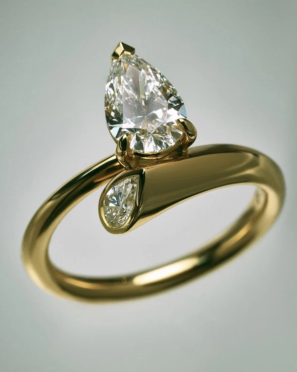 <a href="https://www.sarahandsebastian.com/en-us/products/aria-pear-engagement-ring-yellow-gold">SARAH &amp; SEBASTIAN Ring</a>, $6,665