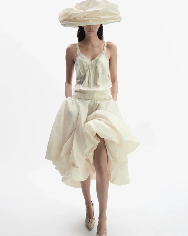 <a href="https://www.magdabutrym.com/fr-en/product/ss26-skirt-01-cream" target="_blank">MAGDA BUTRYM Draped Skirt, $2,095</a>