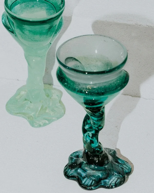 <a href="https://oblist.com/products/flower-cocktail-glass-dark-foot">SZKLO Flower Cocktail Glass</a> from The Oblist, $210