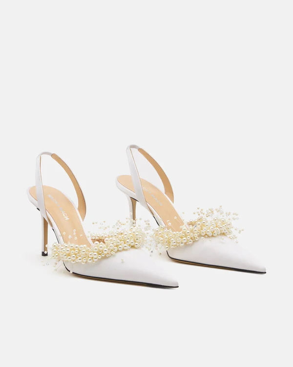 <a href="https://machandmach.com/products/floating-pearl-white-satin-slingback-85mm?_gl=1*18padgr*_up*MQ..*_ga*MTEyMTE0NDcyNy4xNzgxODk1Mjc3*_ga_N8QBVBWCCC*czE3ODE4OTUyNzYkbzEkZzAkdDE3ODE4OTUyNzYkajYwJGwwJGgw*_ga_7NVNMZST7Z*czE3ODE4OTUyODIkbzEkZzAkdDE3ODE4OTUyODIkajYwJGwwJGgyMDI3NzkxMzk2&variant=46288021225720">MACH & MACH Floating Pearl White Satin Slingback</a>, $985