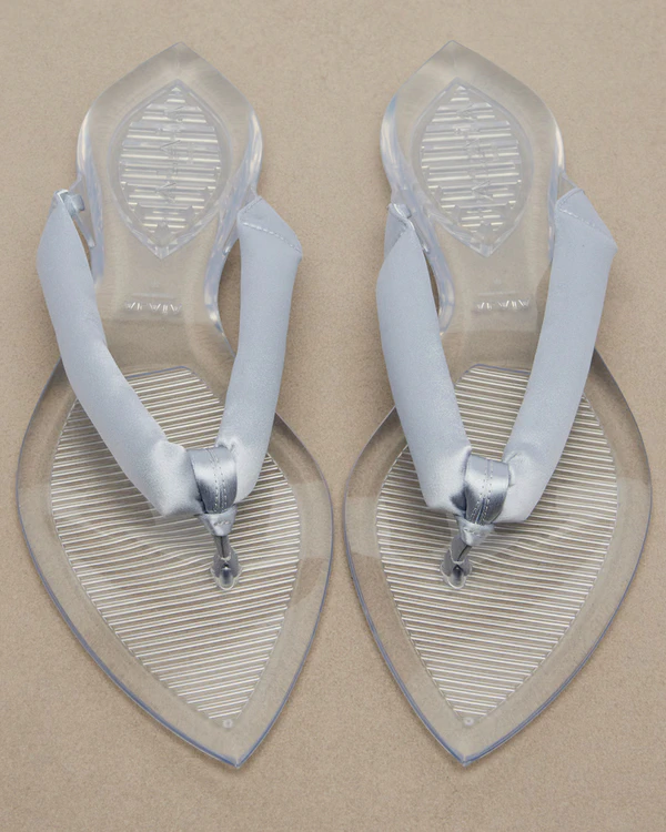 <a href="https://www.maison-alaia.com/en-us/product/sandals/invisible-thong-in-patent-leather-AA3S1005I037U18.html">MAISON ALAÏA Invisible Jelly Thong</a>, $850