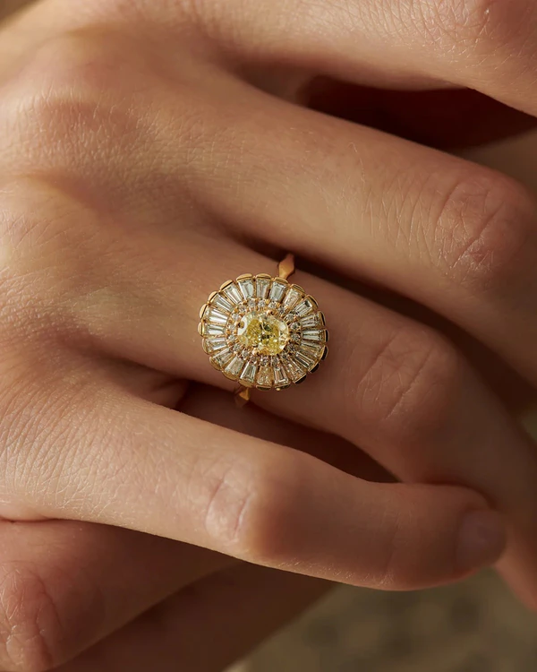 <a href="https://www.artemerstudio.com/collections/color/products/daisy-engagement-ring-fancy-yellow-diamond-and-baguette-diamond-ring">Artemer Studio</a>