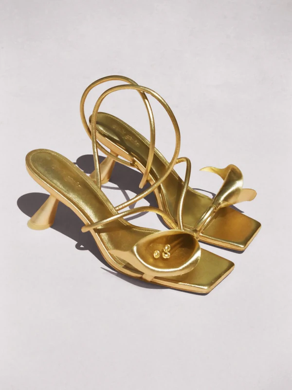 <a href="https://www.net-a-porter.com/en-us/shop/product/cult-gaia/shoes/mid-heel/ria-embellished-metallic-leather-slingback-sandals/46376663162986220?gad_campaignid=23349662580&gad_source=1&gbraid=0AAAAADRhZnvMPkcOu0EtSNlpfuiwV46lt&gclid=Cj0KCQjw2YDQBhD_ARIsAE1qeSdyH5dwFya2Y2pdO-v4yNaHwvOYbqYwe6netf0Kutei0BtJdoues4gaAu7DEALw_wcB&utm_campaign=GOO%3ANAP%3AAP%3AAU%3AOO%3AENG%3ASEAU%3APMX%3AMAN%3AMXO%3ANEW%3AWN%3ALOW-CLUSTERS%3ALV0%3ALV1%3ALV2%3AXXX%3A0%3ALOW-CLUSTERS%3A&utm_id=23354717276&utm_medium=cpc&utm_source=google&utm_term=3074457345630378038&vtp00=GOOGLE&vtp01=SEAU&vtp02=&vtp03=&vtp04=x&vtp05=c&vtp06=&vtp07=pla">CULT GAIA Ria Sandal</a> from Net-A-Porter, $700