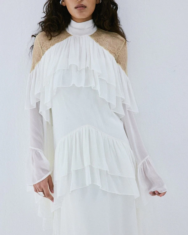 <a href="https://www.delavali.com/products/etereo-maxi-dress-in-ivory-viscose-georgette-and-lace?_su_rec=uzTQ3JMx_-Tn0V1GQy4iO2UD5I0tpsj2jDAQFhzQimaeLiOlLuYtTXxiIUegQubTWjAKzkvpFPaXg229gO3nhkgnk0G3PE0Y4JNsji_kkHU1Wk0FZ-leDVjPc6RtdBduklAsk3bBla_5-4-eag6zeQ0vR8nI_pHcoy5pXNL4yeXDBt4MQhemar1Fbawjl1eHNxDAOubn3vKNqDXgyuHe__u-aBng9BoTrYCYmeGUEtp9_MLm-Q31BWQb6Ioaj6eom1bfPLhXvMpKulWvKH0lRCBjcImKWe6cXTrBsH5Iumlk_--cLFNUu4Z3FbwpfFcvGZA5qw&amp;_su_rec_id=8a959e14-be33-4710-bc5a-a0d066bcad0c-1791271680">DE LA VALI Dress</a>, $1,150